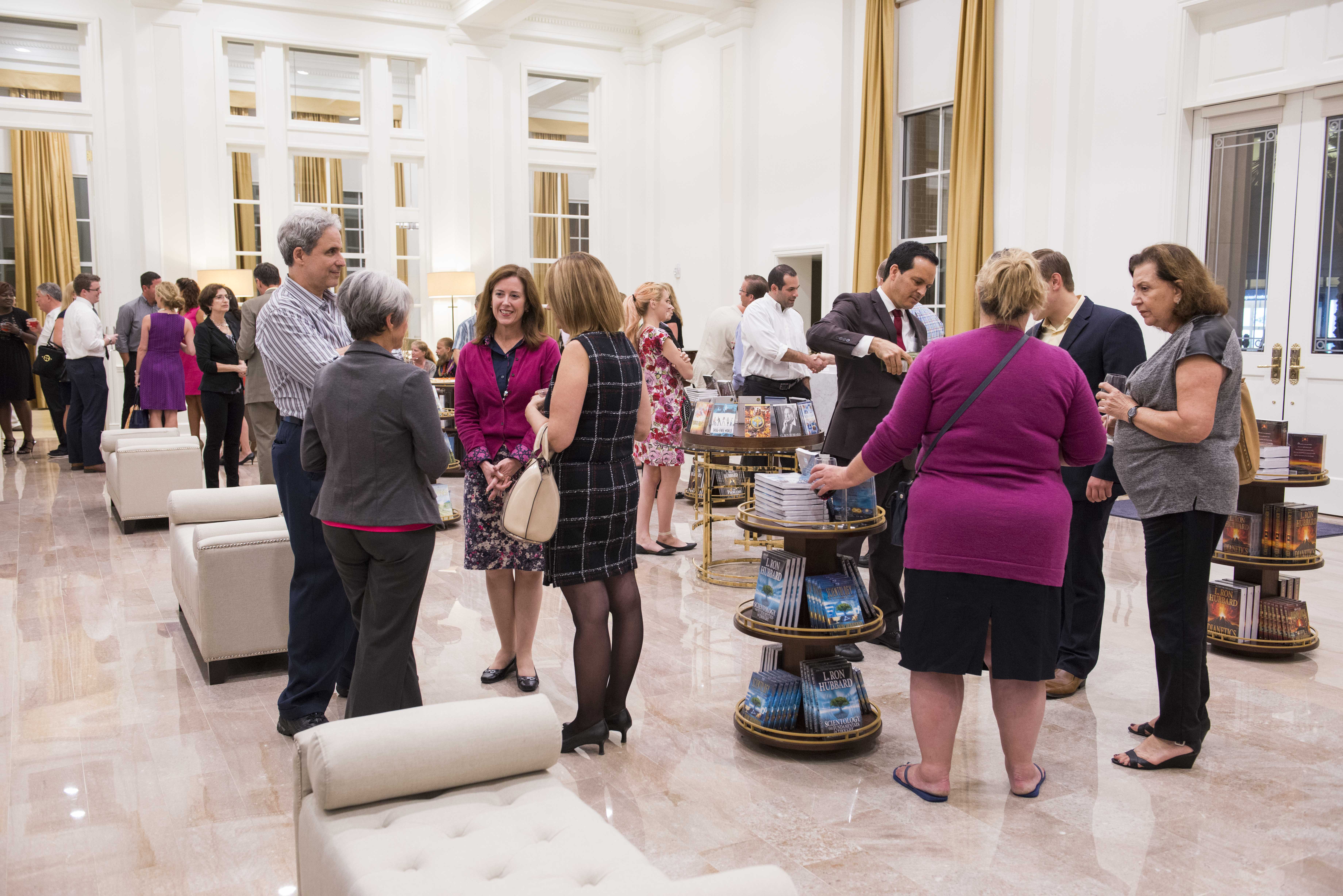 Business professionals networking in the Scientology Information Center.JPG