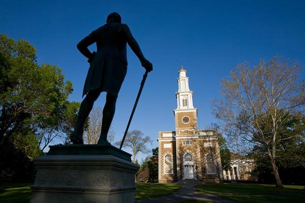 A statue of Alexander Hamilton looks towards the Hamilton College Chapel. The college is named for the first secretary of the U.S. Treasury. Photo by Vickers & Beechler.