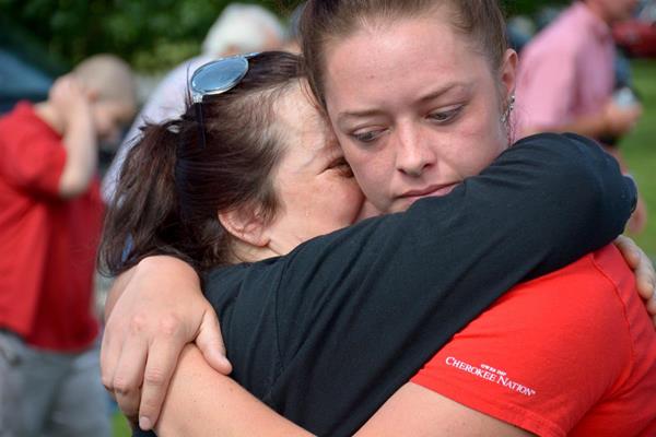 Photo Cutline: Kaycee Deal hugs daughter and 2017 Remember the Removal Bike Ride cyclist Shelby Deal before Deal and other participants leave for three week, 950 mile journey retracing the Trail of Tears.