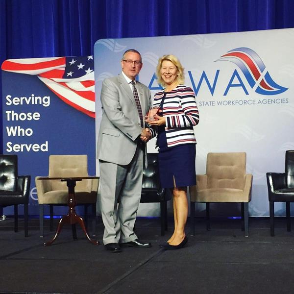NASWA Executive Director, Scott Sanders, presents DirectEmployers Executive Director, Candee Chambers, with veterans employment recognition award at 2017 Veterans Conference in Washington, DC.