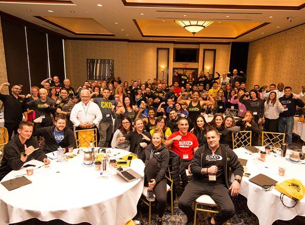 Owners, managers, and corporate staff from the widely popular CKO Kickboxing franchise come together for a photo.