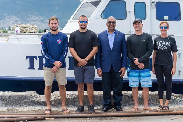 Haiti's Prime Minister and several Mission of Hope staff members in front of True North before it departed for the Turks and Caicos Islands.