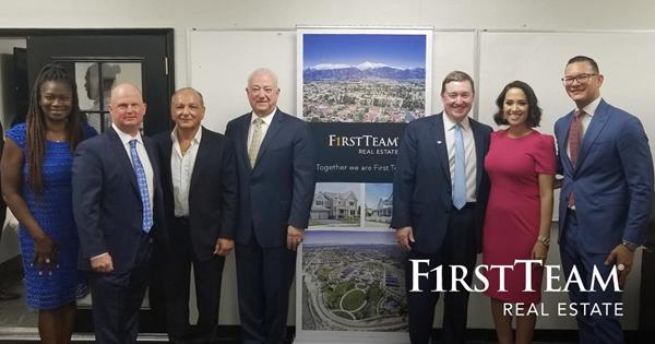 The executive teams of First Team Real Estate and Lawyers Realty gather to celebrate the new merger.