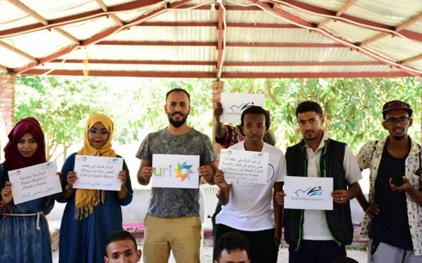 URI member group "Youth of Peace, Yemen" holds up peace signs. Under the travel ban, Yemenis will not be allowed to emigrate to the US, resulting in fractured families and limiting their options to escape violence.