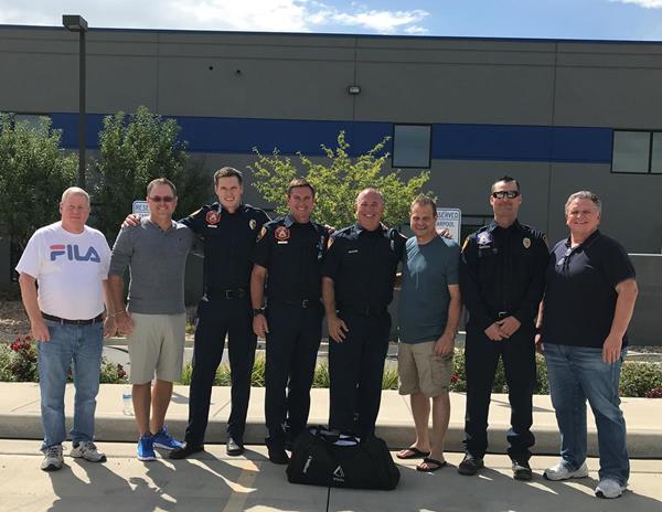 Members of PRMI's executive leadership team present firefighters from Salt Lake City Fire Station 11 with upgraded communication system.