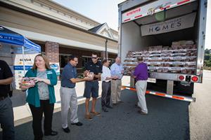 Representatives unloaded a portion of Smithfield's Helping Hungry Homes donation.jpg