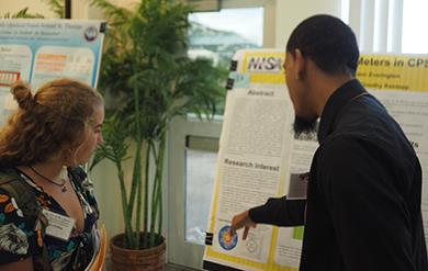 Student researcher interacts with an attendee at the annual Fall Science Symposium on the University of the Virgin Islands Campus in the Administration and Conference Center -  September 22, 2018.