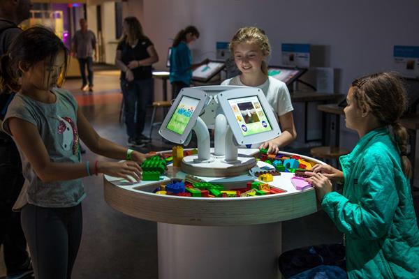 In Animaker, a new AI experience debuting at The Tech Museum of Innovation, visitors build animals out of physical blocks before a robot scans and takes a guess at what they've built. They can customize the creature's look and behavior in a digital jungle. Photo by Nick Leoni