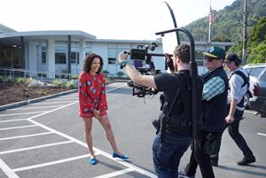 Susie Castillo, host of Cultural Capital, filming outside of The RealReal office