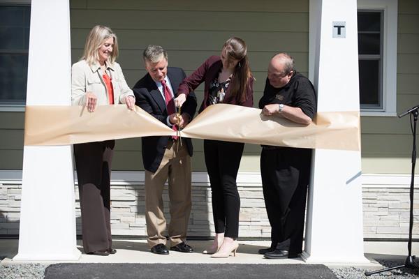 Participating in Husson University’s ribbon cutting ceremony for their new townhouses were (from left to right), Pamela Kropp-Anderson, Husson University’s dean of student life, Robert J. Ronan, '79, chair of the University Board of Trustees, Madeline Sanborn ’18, a Husson student trustee pursuing a Bachelor of Science degree in health sciences, and Dr. Robert A. Clark, Husson University president.