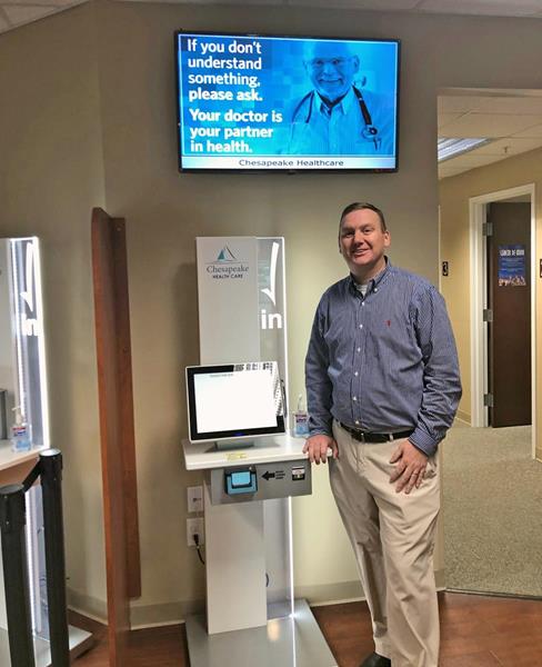 Josh Boston with Chesapeake Health Care's new Clearwave Patient Self-Service Registration Kiosks.
