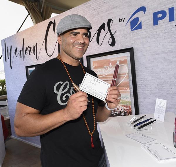 Emmy Presenter and Tony Award Nominated Actor for his performance as George Washington in Hamilton, Christopher Jackson, writes his motto, "Forward", with Pilot Pen's Vanishing Point retractable fountain pen, with a 18-karat gold nib at the GBK and Pilot Pen Luxury Lounge.