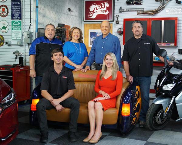 The MotorWeek team takes a break on the set. Pictured left to right are (sitting) Zach Maskell, Stephanie Hart, (standing) Pat Goss, Yolanda Vazquez, series host John Davis, and Brian Robinson.