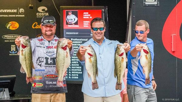 Pro bass angler Jason Lambert of Michie, Tennessee, shows off his record-breaking limit with FLW emcees Chris Jones and Daniel Fennel.
