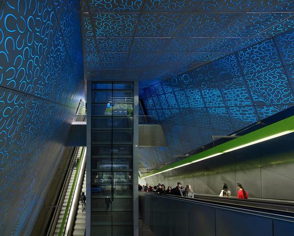 At the heart of the station, the escalators and glass elevator pass through a 55-foot high underground central chamber, one of the highest interior volumes in the city. LMN Architects and artist Leo Saul Berk collaborated to create an integrated experience for travelers, where the architecture seamlessly merges with Berk’s artwork, "Subterraneum," that expresses the geological layers of soil surrounding the station walls. Photo by Kevin Scott
