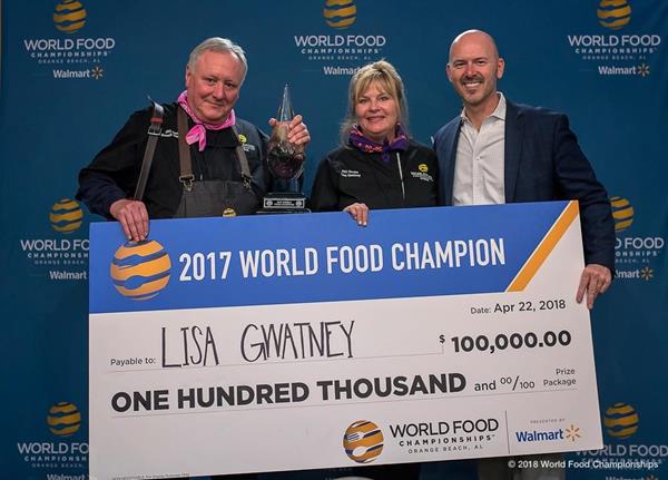 (From left to right: Russell Gwatney, Lisa Gwatney and Mike McCloud). 2017 World Food Champion, Lisa Gwatney, is presented with a $100,000 check.