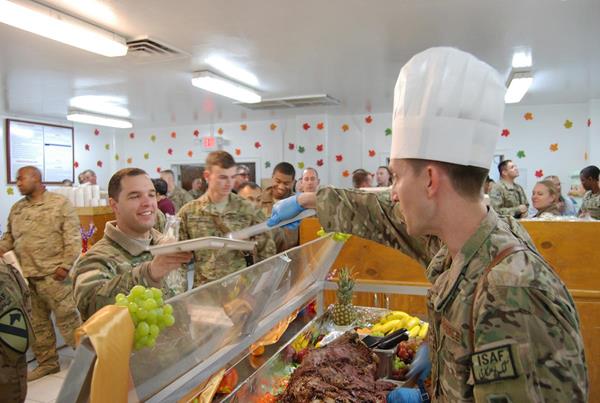 Air Force Col. Aaron Steffens, 455th Air Expeditionary Wing vice commander, serves Thanksgiving meals to service members at Bagram Air Field, Afghanistan, in 2013. Each year, Subsistence supply chain professionals at the Defense Logistics Agency ensure American service members around the world are able to enjoy a traditional Thanksgiving meal (U.S. Air Force Photo by Capt. Brian Wagner)