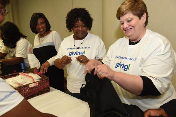 Baton Rouge Mayor-President Sharon Weston Broome and UnitedHealthcare employees assemble gift bags for mothers in the GRACE Program, which will help minimize the adverse effects of opioid misuse during pregnancy. 