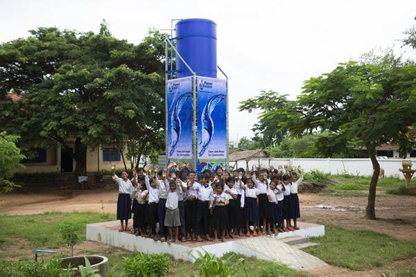 Children celebrate receiving a Planet Water Foundation AquaTower water filtration system at their school located in the Svay Leu District of Siem Reap Province, Cambodia. AquaTowers remove bacteria, protozoa, viruses and other harmful contaminants, and support the daily drinking water requirements of up to 1,000 people.