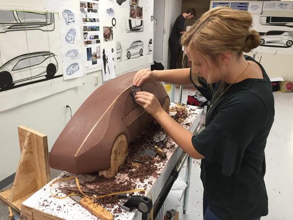 Kelly Miller from Cedarville University's Industrial and Innovative Design program uses clay to design as prototype of a Chevrolet 2+2 battery electric car. (Photo by Scott Huck, Cedarville University)