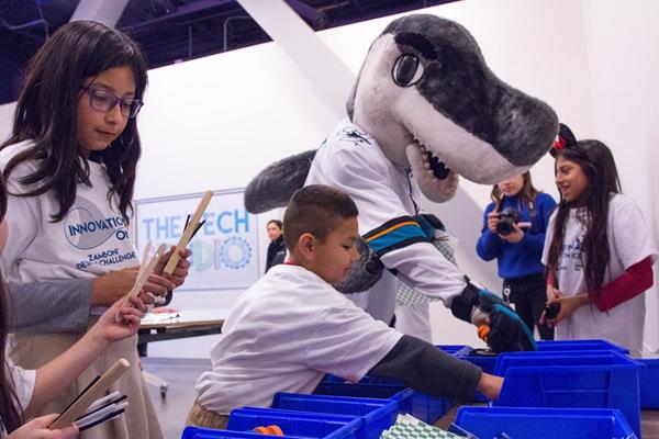 Sharkie and students select materials to build a wind-powered ice resurfacer as part of the Innovation on Ice partnership with The Tech Museum of Innovation, Sharks Foundation and SAP. Innovation on Ice: Code Teal will allow students to learn coding in an ice hockey-themed STEM activity. (San Jose, CA)