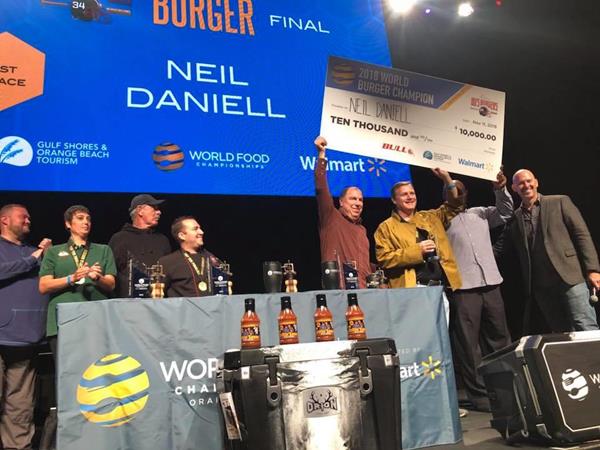 2018 World Burger Champion receiving his $10,000 check from WFC's CEO Mike McCloud and Burger Sponsor and two sport All-Star athlete, Bo Jackson.