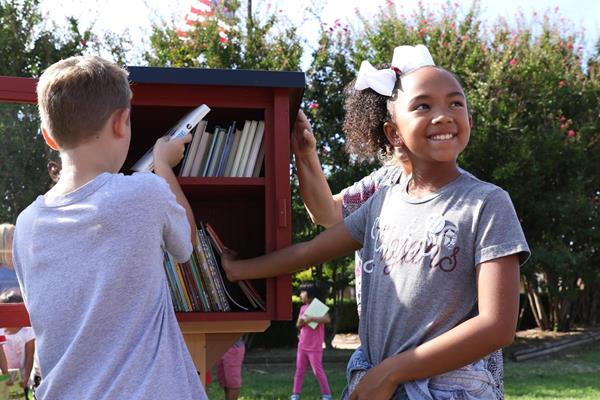 Students at Jenks East Elementary add books to the world's 75,000th registered Little Free Library book exchange. This Little Library is part of a global network of "take a book, share a book" locations, which foster a love of reading and a sense of community.