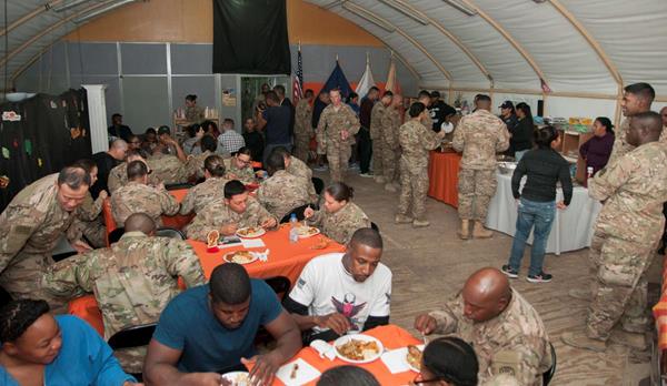 U.S. soldiers from the Army’s 369th Sustainment Brigade eat a Thanksgiving holiday meal at Camp Arifjan, Kuwait, Nov. 26, 2016. Each year, DLA Troop Support Subsistence supply chain employees ensure service members around the world get to enjoy a traditional Thanksgiving meal. (U.S. Army photo by Sgt. Jeremy Bratt)