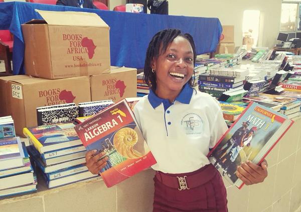 A BFA recipient in Sierra Leone enjoys a new set of textbooks thanks to a partnership with Sierra Leone Book Trust