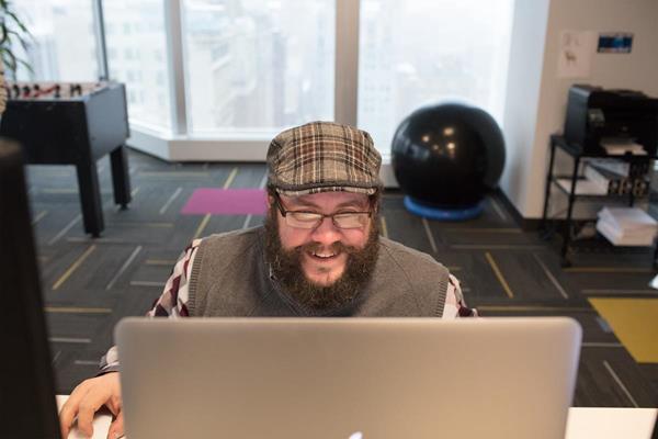 Skyword's Director of Web Development, Michael Shaheen, working in the Skyword Pittsburgh technology headquarters on the 19th floor of PPG Place.