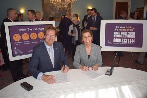 Rt. Hon. Tobias Ellwood MP - Parliamentary Under Secretary of State and Minister for Defence People - and Veterans and Barbara Van Dahlen - PhD, Founder and President of Give an Hour, the lead organization for the Campaign to Change Direction - sign a MOU signifying their new partnership.