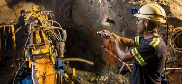 A member of the Titan drilling team operating a drill rig underground at Kipushi