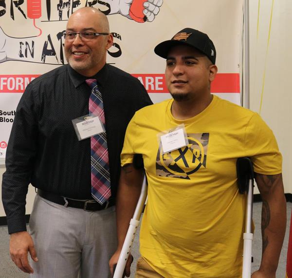 George Ortiz, right, who received an emergency transfusion of type-O blood as part of emergency medical care, is pictured with Michael Noriega, whose blood Ortiz received during his treatment, at the Brothers in Arms event.