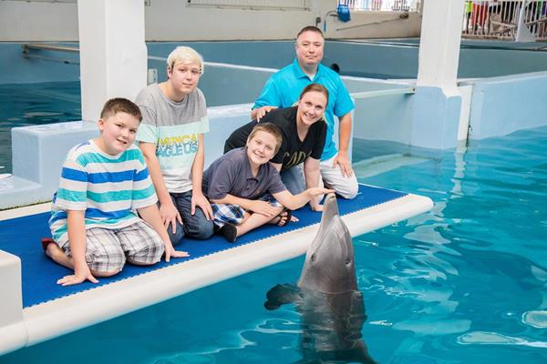 From left to right: John, Ryan, Charley, Jeannie and Jody Thompson meet Winter the Dolphin at Clearwater Marine Aquarium. 