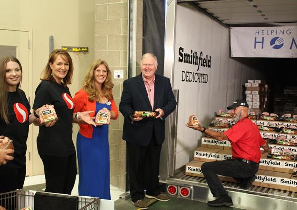 Representatives from Safeway, Oregon Food Bank and Smithfield unload a portion of Smithfield's 25,000lb Protein Donation
