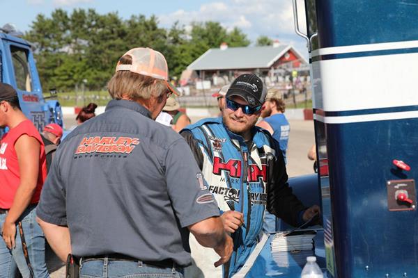 Tyler Kruckeberg (#54) signs an autograph for a fan during the Bandit Series meet-and-greet prior to the race at La Crosse Speedway Saturday, July 28th.