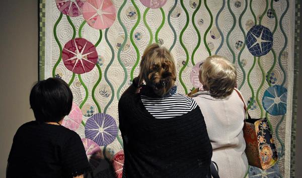 Visitors experience the exhibit "Japanese Quilt Artists that Influenced the World" at The National Quilt Museum.