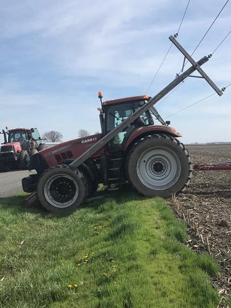 A tractor sits in a rural central Illinois field after hitting a power pole while planting. Photo Courtesy of: Energy Education Council