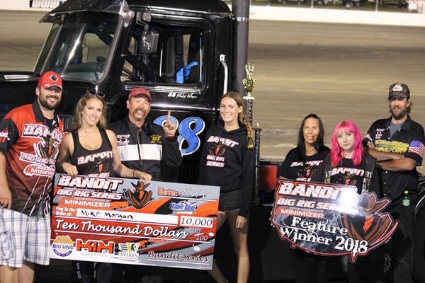 Bandit Mike Morgan (third from left) celebrates his a-main feature win at Lake Erie Speedway Saturday night.  Morgan earned a $10,000 check for his efforts.