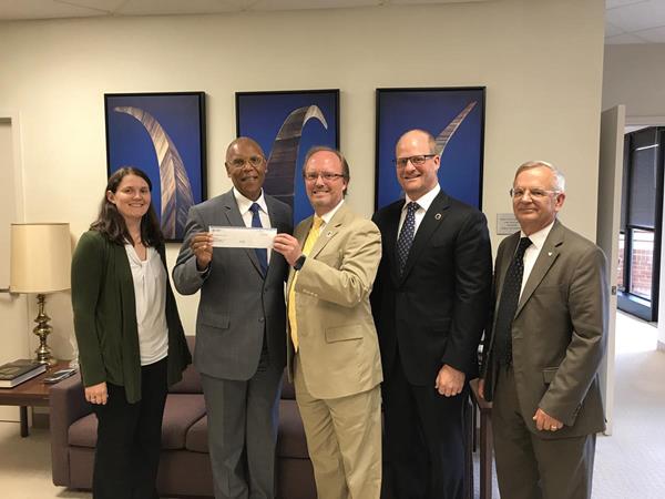 Col. (Ret.) Lance Spencer, Director-Defense, AT&T Global Public Sector (center), and Rocky Thurston, Associate Vice President and Client Executive-Defense, AT&T Global Public Sector (center-right), present a check on behalf of AT&T to General (Ret.) Larry Spencer, Air Force Association President (center-left), Brig. Gen. (Ret.) Bernie Skoch, CyberPatriot National Commissioner (far right), and Rachel Zimmerman, CyberPatriot Director of Business Operations at AFA Headquarters in Arlington, Va. (far left). The check represents AT&T’s continued support of AFA’s CyberPatriot program.