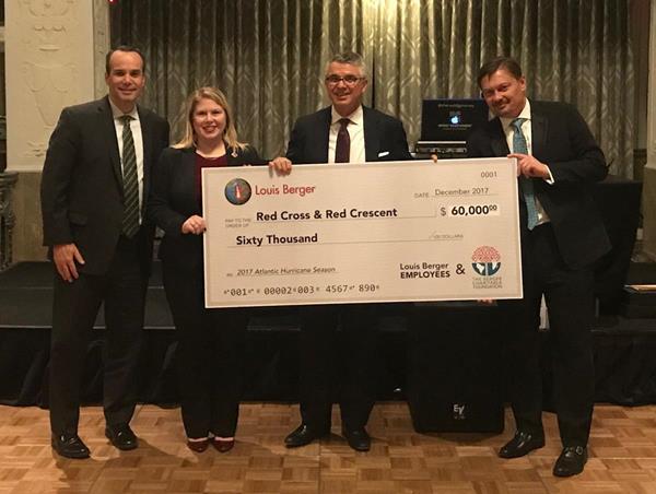 Red Cross representative Jessica Adams (second from left) accepts the Louis Berger contribution of $60,000 from (L-R) Tom Lewis, U.S. division president; Jim Stamatis, CEO; and Jiri Maly, operations and maintenance division president.
