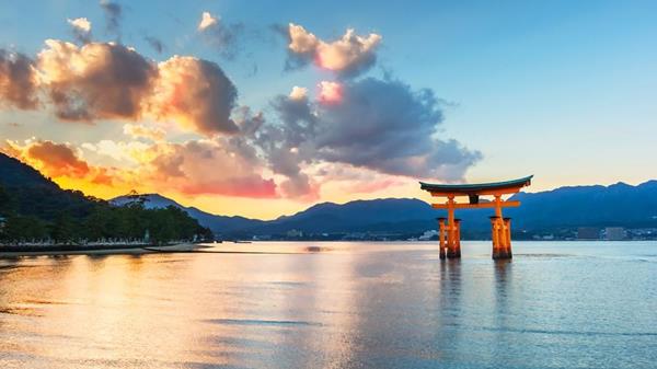 Zegrahm guests photograph the iconic scarlet torii, a giant camphor-wood gate at the entrance to the Itsukushima Shrine, a World Heritage Site and a sacred site of pilgrimage. At high tide it appears to float in the surrounding waters.