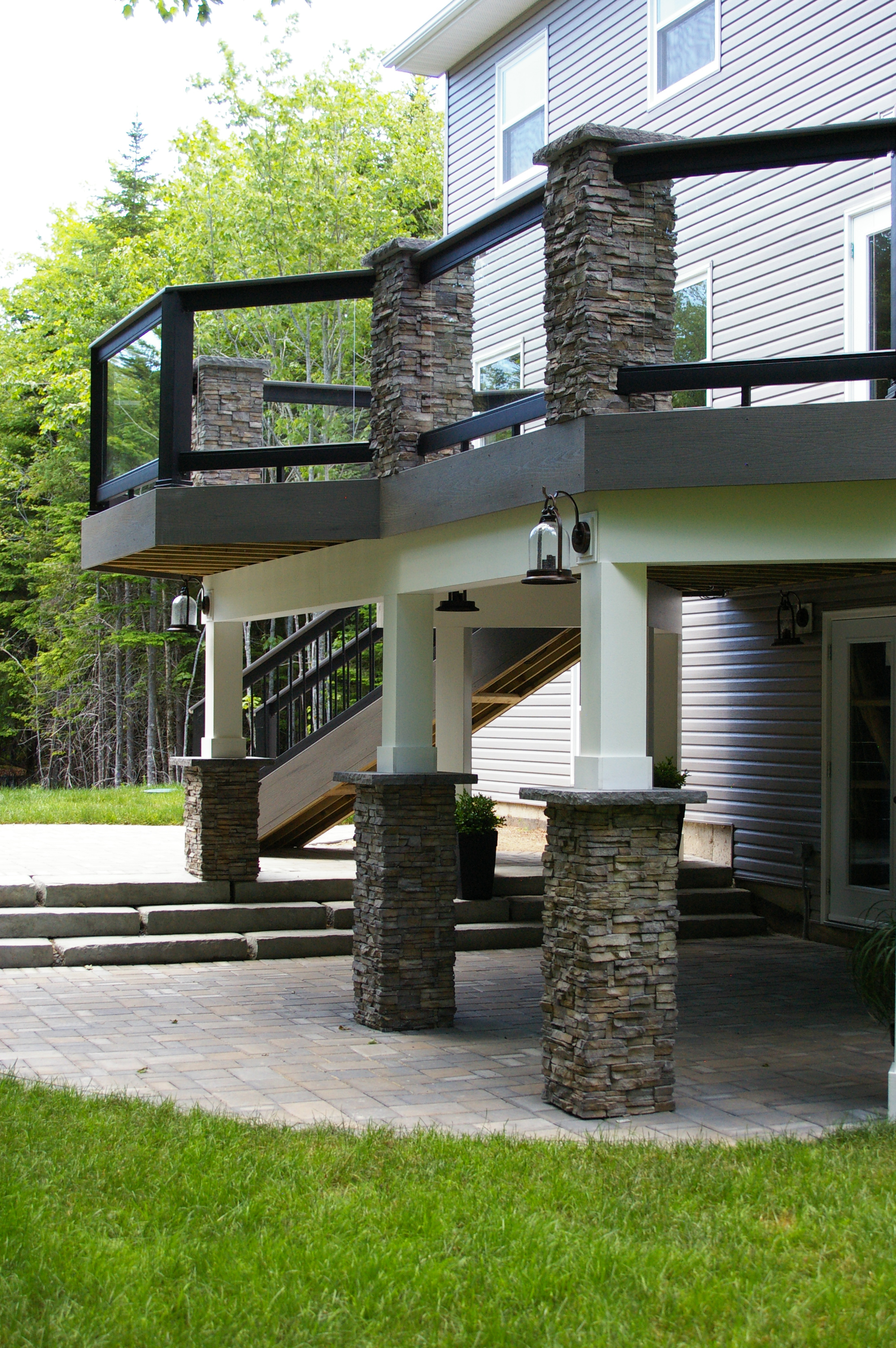 Archadeck of Nova Scotia’s award-winning deck project is an exquisite multi-level entertainment area. Below the renovated deck is a new curved Trevista paver patio. Stone steps leading from the shaded area below the deck to the exposed patio area by the deck’s stairs allow the homeowners to lounge in the shade or sunshine. 
