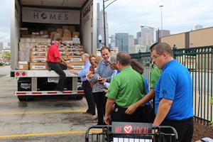 Representatives passed a portion of Smithfield's Helping Hungry Homes donation.JPG