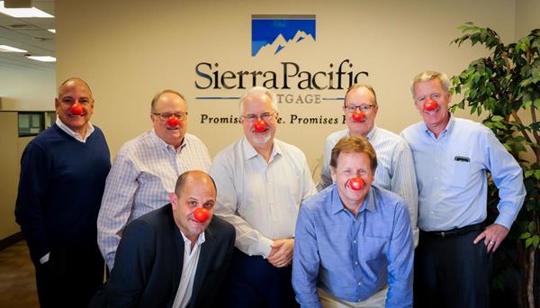 Sierra Pacific Mortgage's Executive Team wearing their red noses! From Left to Right: (back row) Rick Bargioni - Vice President of National Operations, Gary Clark - Chief Operating Officer, Paul Hubbard - Chief Financial Officer, Lonnie Adams - Vice President Capital Markets, Jim Connell - Chief Information Officer. (front row) Jay Promisco - Vice President of Retail Lending, Chuck Iverson - Executive Vice President.