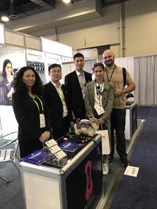 Several Dogness staff members pose at the Dogness booth at CES 2018