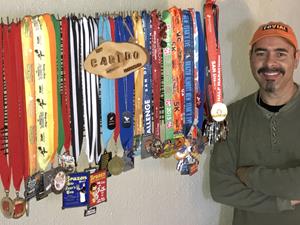 Johnny Ray Nelson in front of his numerous racing medals