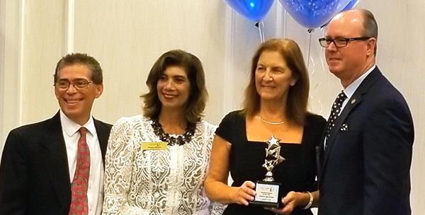 Minuteman Press franchisee Gloria Jacaruso accepts Small Businesswoman of the Year award from the Pompano Beach, Florida Chamber of Commerce.