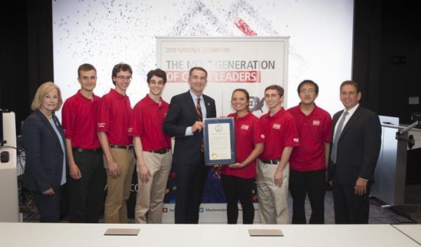 Governor Ralph Northam (D-VA) and Virginia State Delegate Kathleen Murphy (far left) offers a proclamation that recognizes the University of Virginia team's victory in the National Collegiate Cyber Defense Competition. 