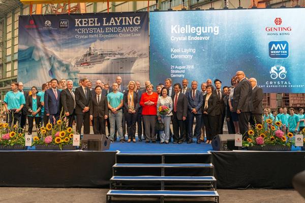 Federal Chancellor Angela Merkel, Prime Minister Manuela Schwesig, Genting Hong Kong's Executive Chairman and CEO Tan Sri Lim Kok Thay, Crystal President and CEO Tom Wolber, and other guests including members of the MV WERFTEN team take the stage for the keel laying of Crystal Endeavor